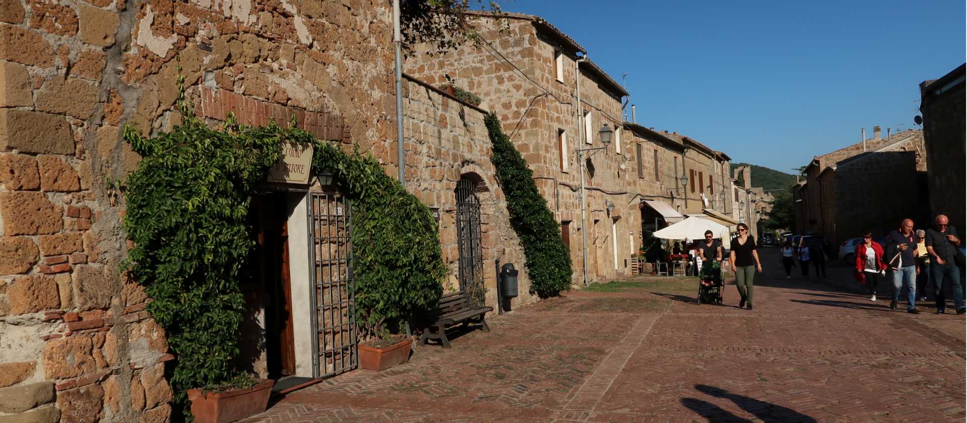Hikers walking through the charming main street of Sovana | Kate Baker