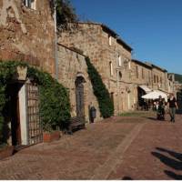 Hikers walking through the charming main street of Sovana | Kate Baker