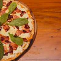 Freshly baked and topped with Italian classics—because every great journey deserves great pizza. | Getulio Moraes
