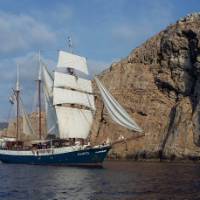 The Atlantis with full sails, making its way by wind power along the coast of Tuscany