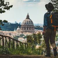Pilgrim walking into St Peters in Rome at the end of the Via Francigena |  Tim Charody