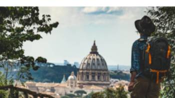 Pilgrim walking into St Peters in Rome at the end of the Via Francigena