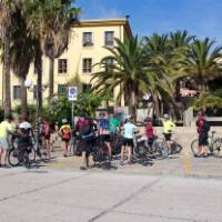 Cyclists in the town of Portoscuso which connects Sardinia to Carloforte