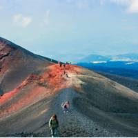Walking up to the volcanic summit of Mount Etna in Italy