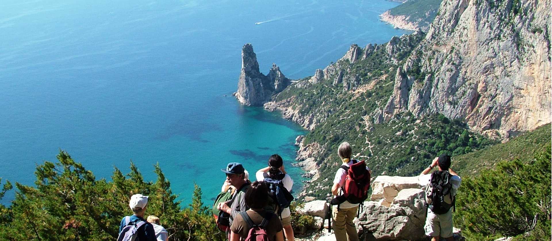 Hiking group above the sea in Sardinia