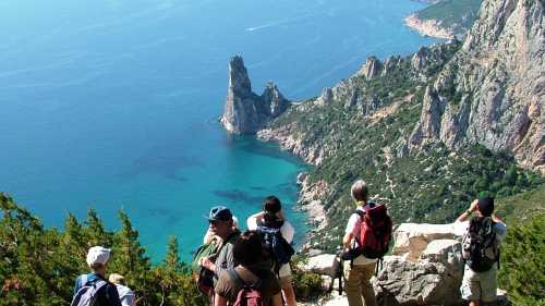 Hiking group above the sea in Sardinia