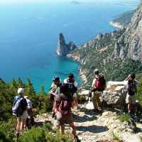 Hiking group above the sea in Sardinia