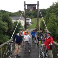 Cyclists on a bridge over the River Sauer in Luxembourg