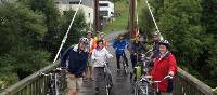 Cyclists on a bridge over the River Sauer in Luxembourg