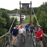 Cyclists on a bridge over the River Sauer in Luxembourg