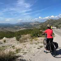 Cyclist taking in the view in Bosnia | Kate Baker
