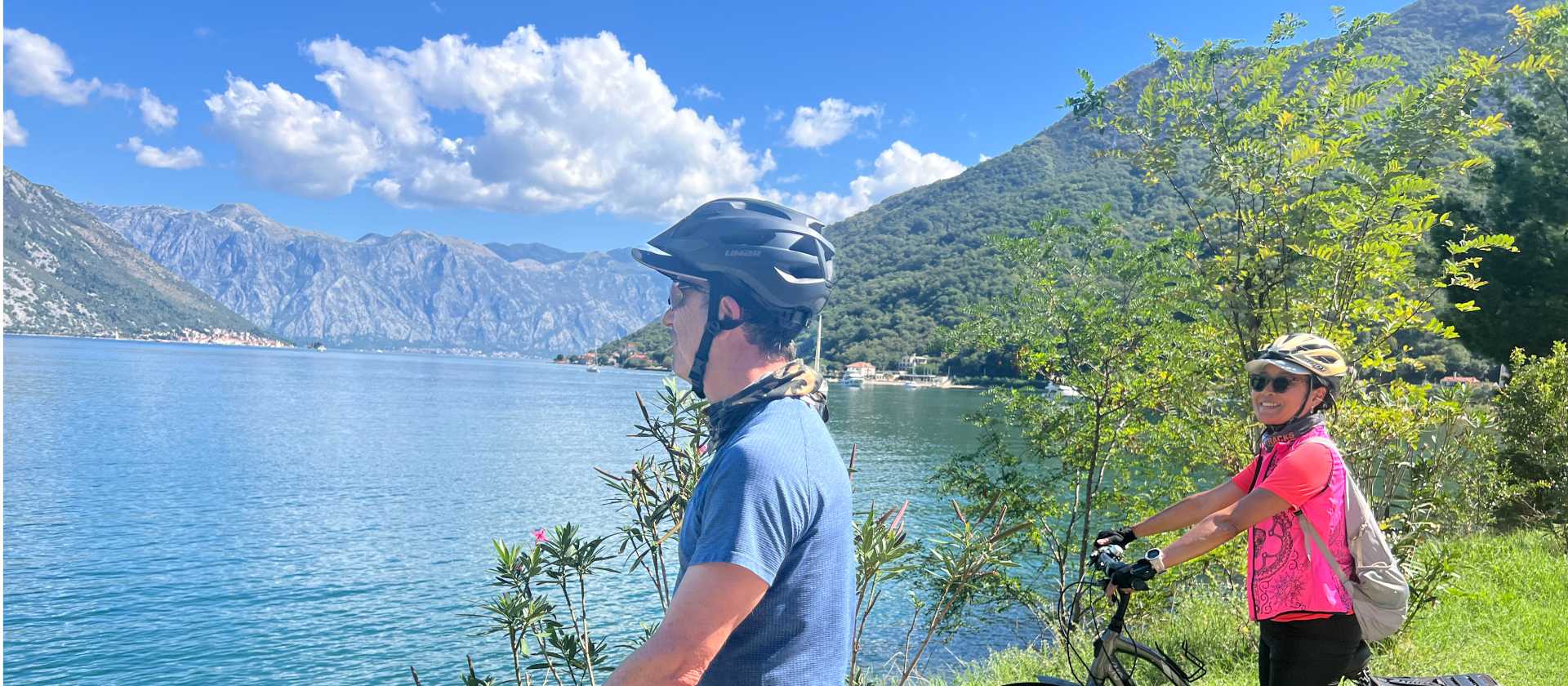 Cyclists taking in view of Bay of Kotor | Kate Baker