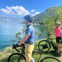 Cyclists taking in view of Bay of Kotor | Kate Baker