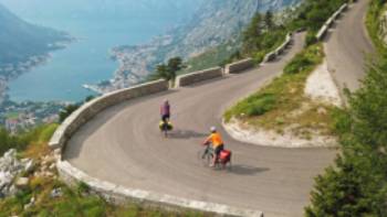 Cruising down the winding roads towards the Bay of Kotor on the Montenegro to Albania Coastal Cycle