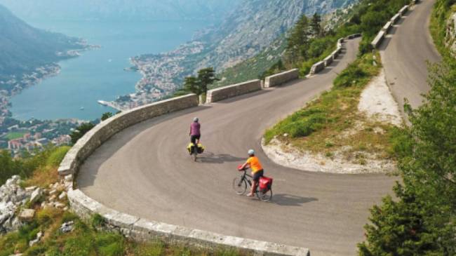 Cruising down the winding roads towards the Bay of Kotor on the Montenegro to Albania Coastal Cycle