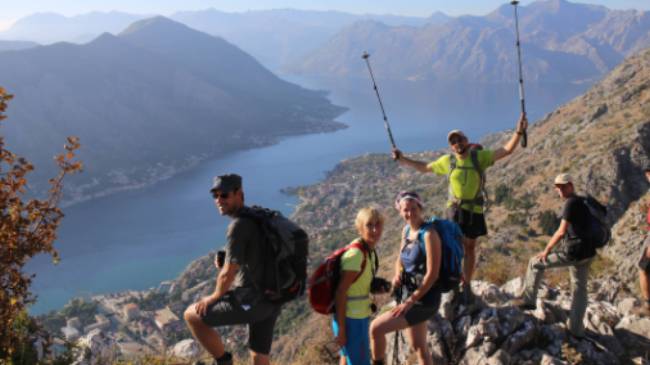 The triumph of reaching the viewpoint over the Bay of Kotor in Montenegro