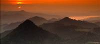 The sky is lit up by the fading sun over the Tatra mountain range in Poland