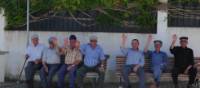 Cycling by friendly men resting on park benches in the Alentejo