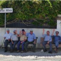 Cycling by friendly men resting on park benches in the Alentejo