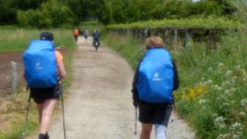 Cyclist passing pilgrims on the trail to Santiago in Portugal