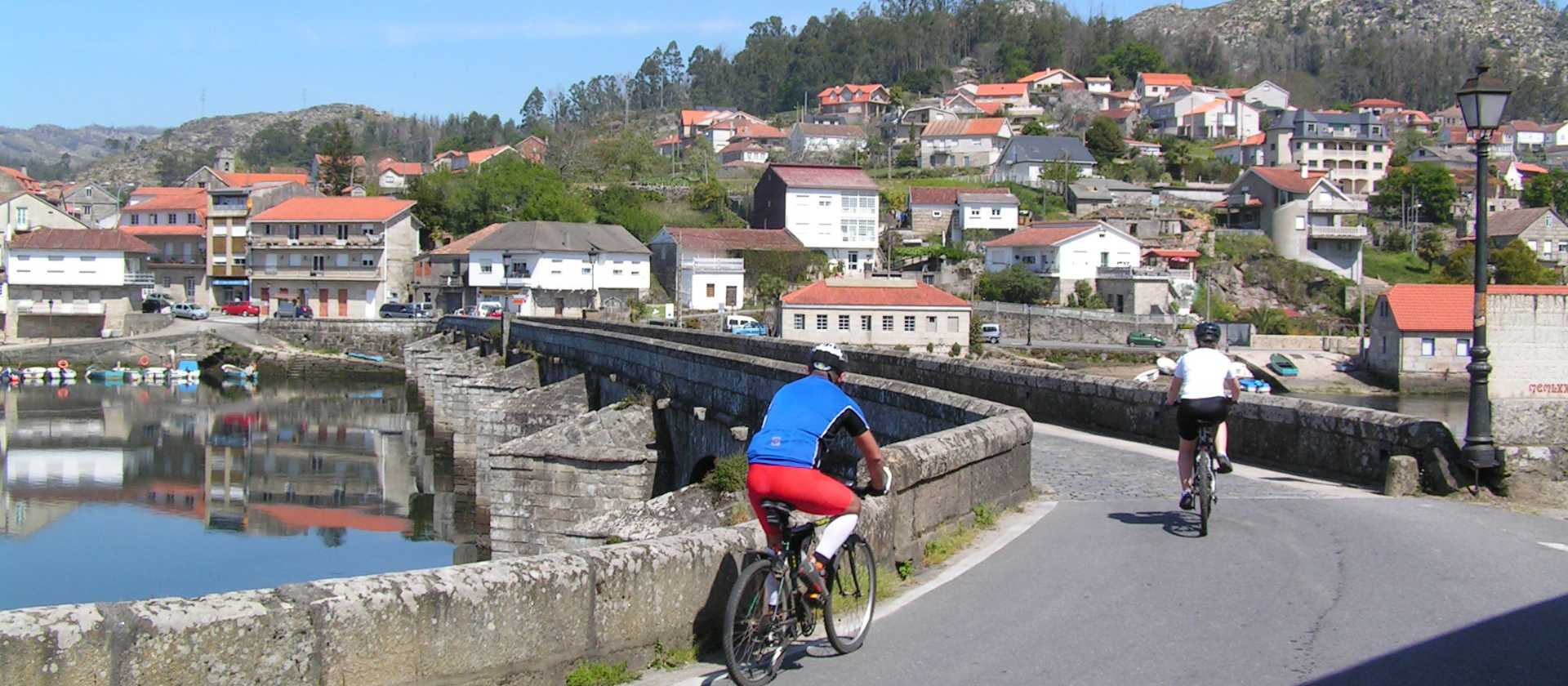 Cyclists entering a village on the Portuguese Camino