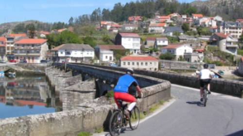 Cyclists entering a village on the Portuguese Camino