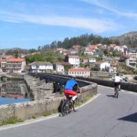 Cyclists entering a village on the Portuguese Camino