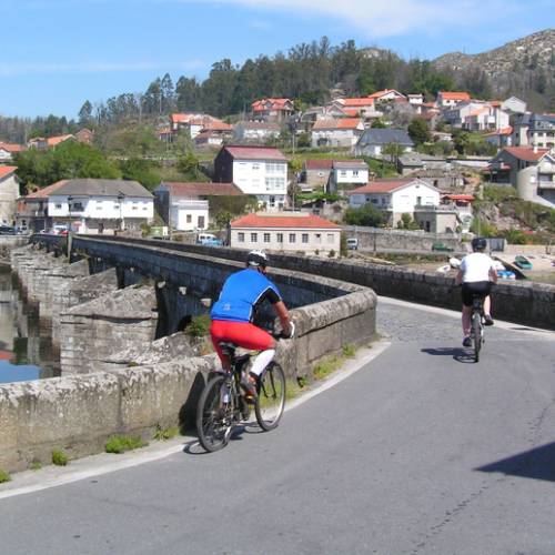 Cyclists entering a village on the Portuguese Camino