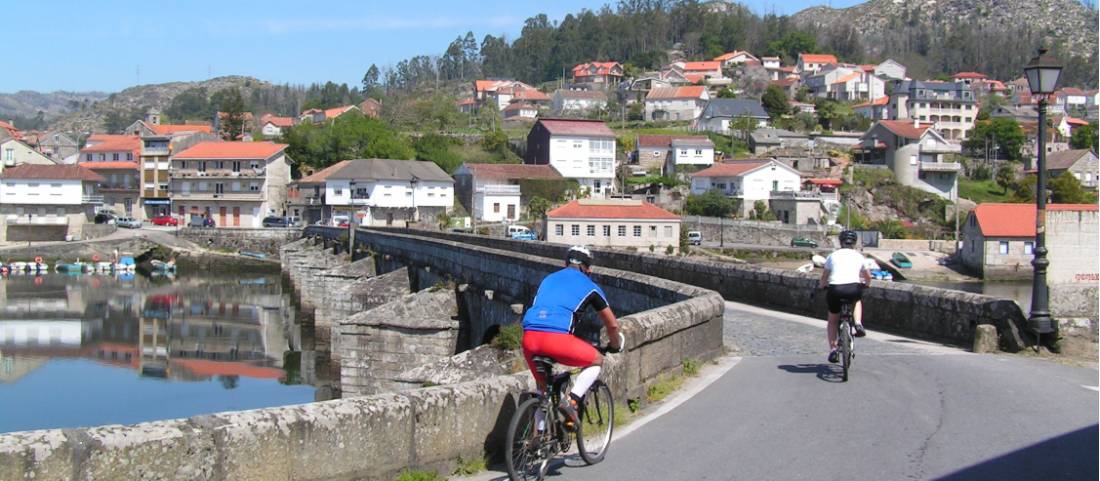 Cyclists entering a village on the Portuguese Camino