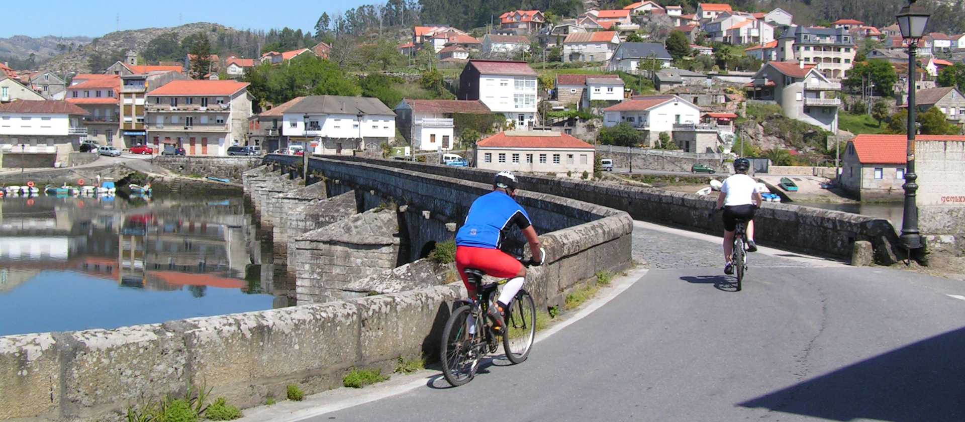 Cyclists entering a village on the Portuguese Camino