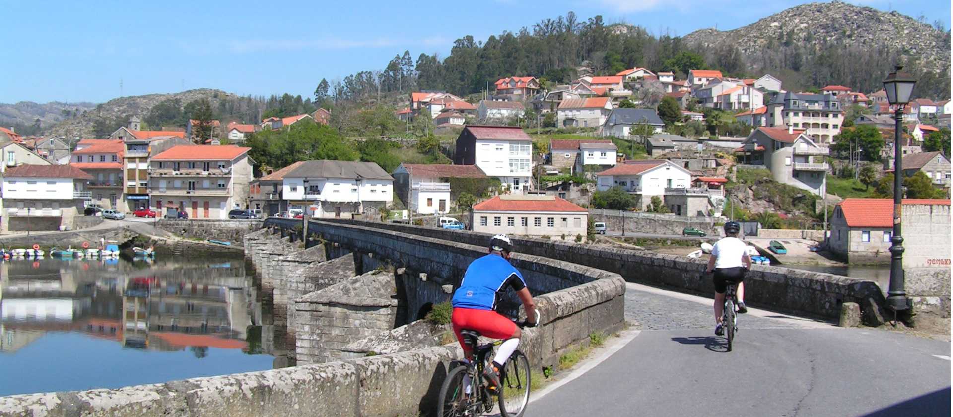 Cyclists entering a village on the Portuguese Camino