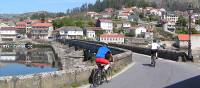 Cyclists entering a village on the Portuguese Camino