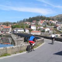 Cyclists entering a village on the Portuguese Camino