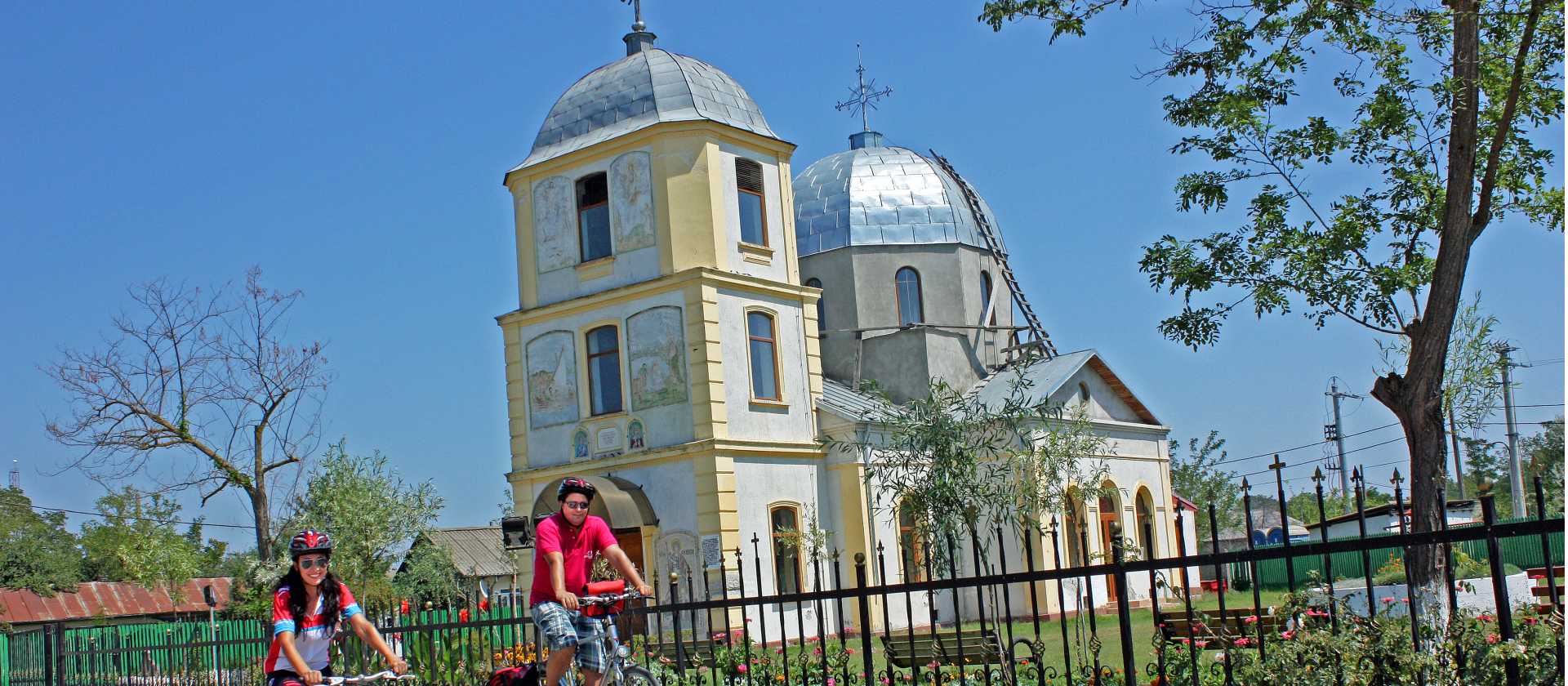 Cycling past a Romanian orthodox church on the Danube Delta