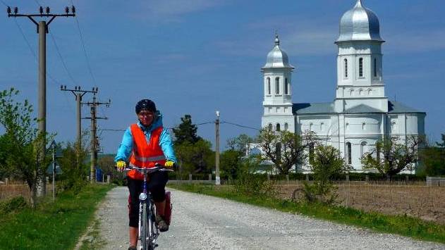 Cyclist on the Danube Delta quiet side road