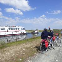 Cyclists watching the boat on the Danube Delta