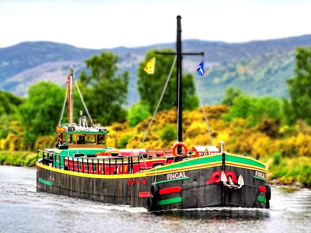 The comfortable floating hotel barge, Fingal, approaching Inverness