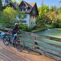 Cycling beside one of Slovenia’s clear alpine waterways, surrounded by the Julian Alps