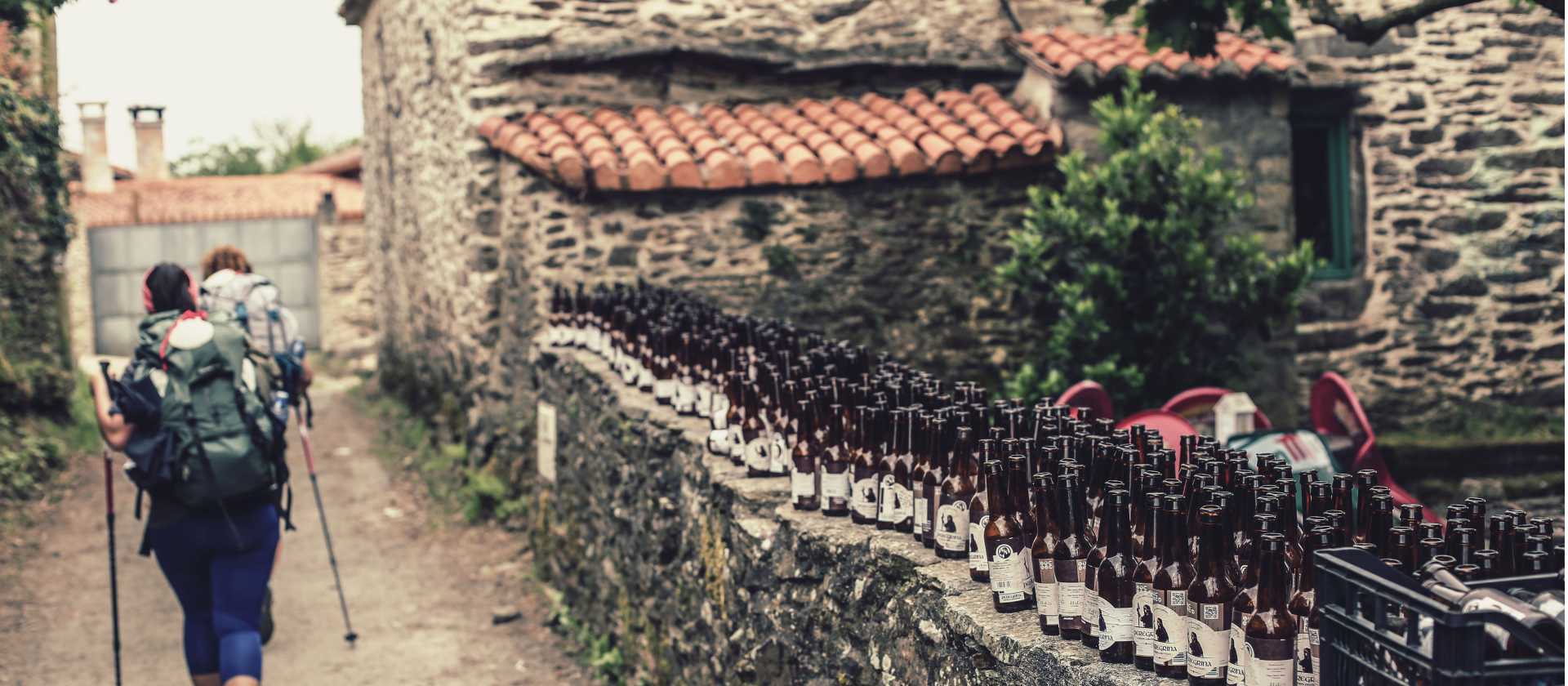 Pilgrims hiking through small village on the Camino | @timcharody