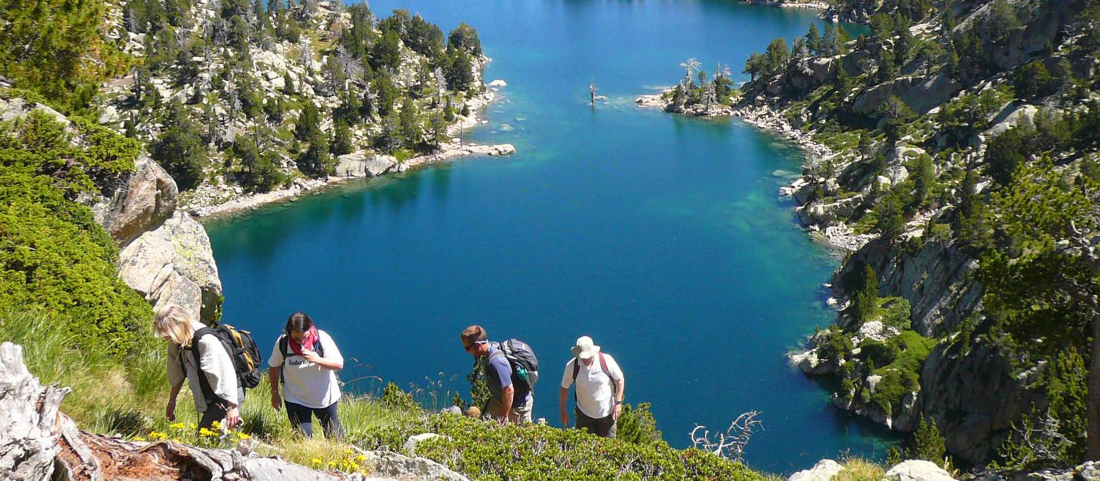 Hikers ascending above the lakes in the Aigues Tortes