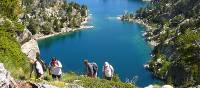 Hikers ascending above the lakes in the Aigues Tortes