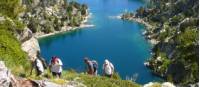 Hikers ascending above the lakes in the Aigues Tortes