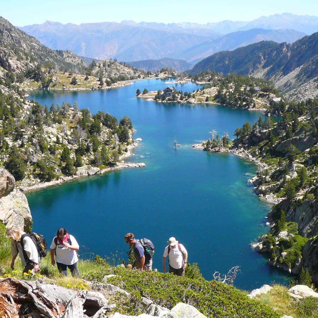 Hikers ascending above the lakes in the Aigues Tortes