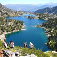 Hikers ascending above the lakes in the Aigues Tortes