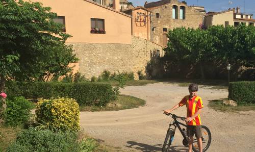 Teenage boy on bike at base of the village of La Pera on a self guided cycle trip in Catalonia&#160;-&#160;<i>Photo:&#160;Kate Baker</i>