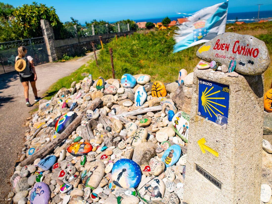 Pilgrims leave painted rocks at the Hito de Mougás waymark.   |  Tim Charody