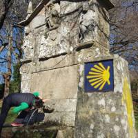 Pilgrim drinking from a fountain on the Camino Sanabres trail to Santiago