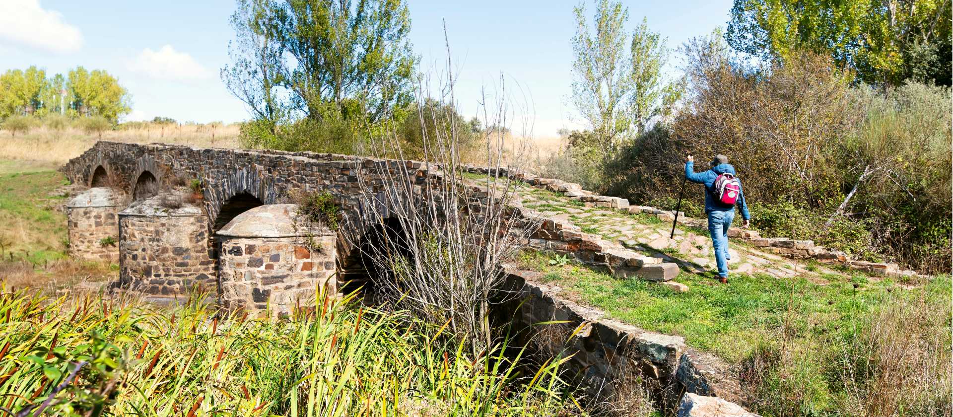 Walking over a bridge on the Camino de Santiago