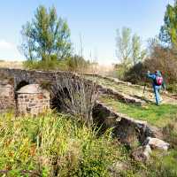 Walking over a bridge on the Camino de Santiago