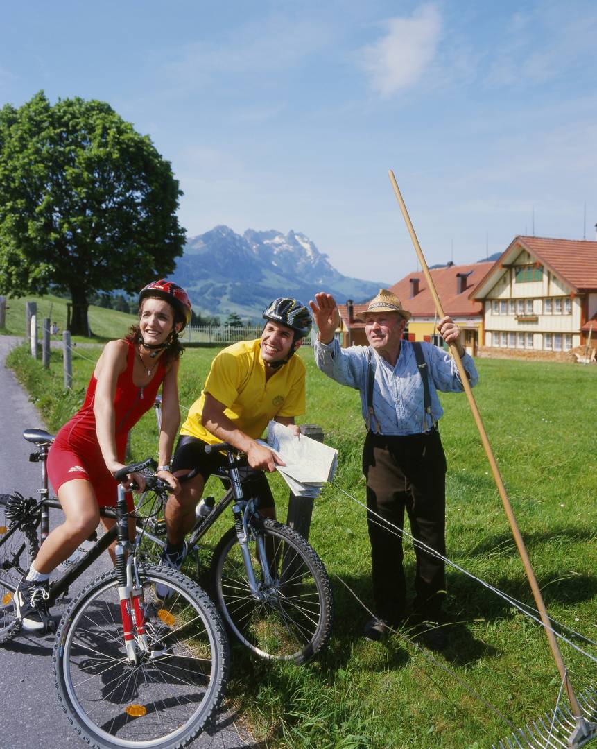 Cyclists getting directions from a local farmer in Switzerland